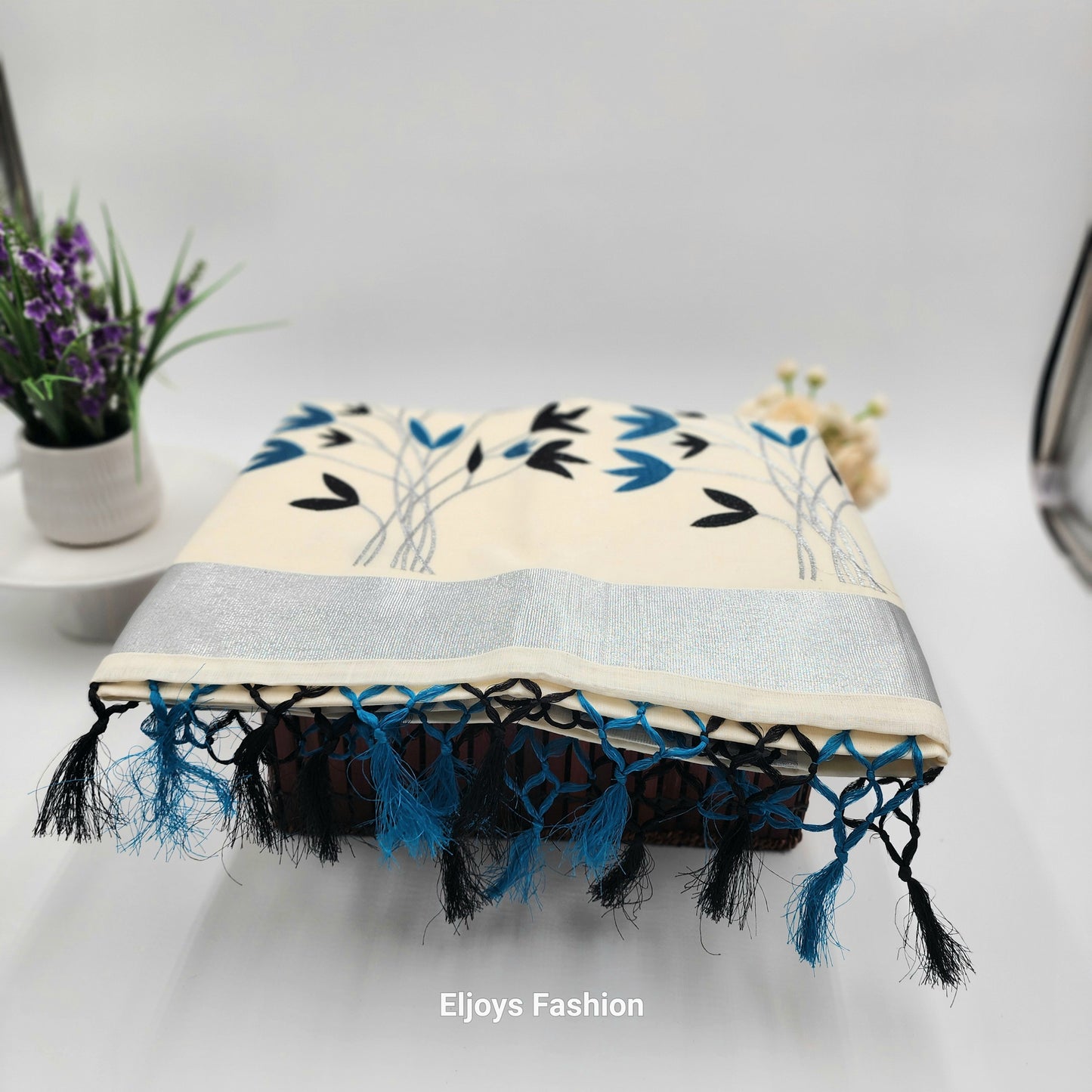 Tissue Silk Saree featuring Silver, Blue and Black floral design with Silver border.