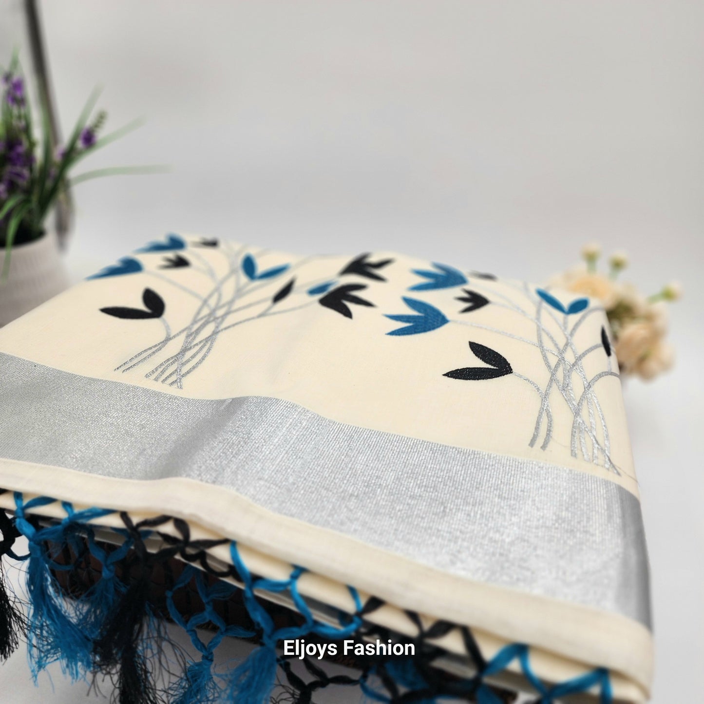 Tissue Silk Saree featuring Silver, Blue and Black floral design with Silver border.