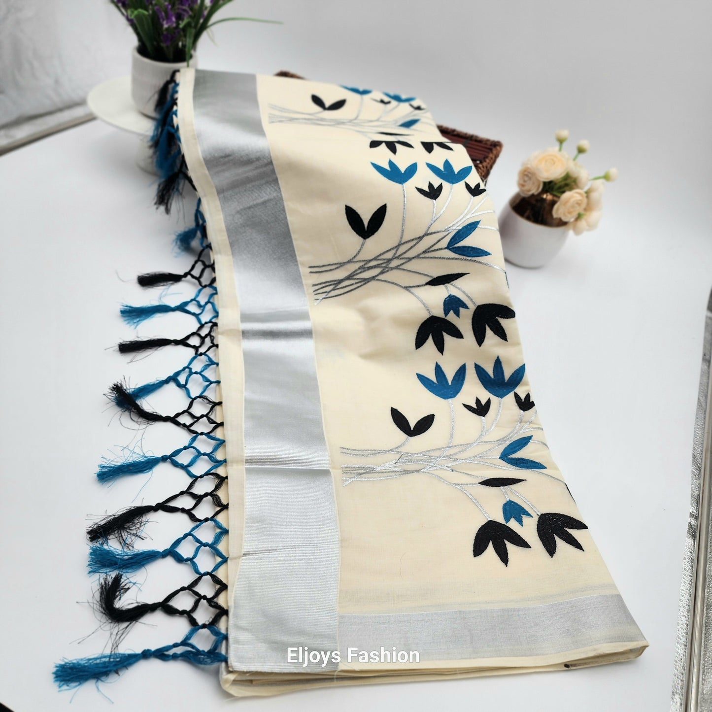 Tissue Silk Saree featuring Silver, Blue and Black floral design with Silver border.