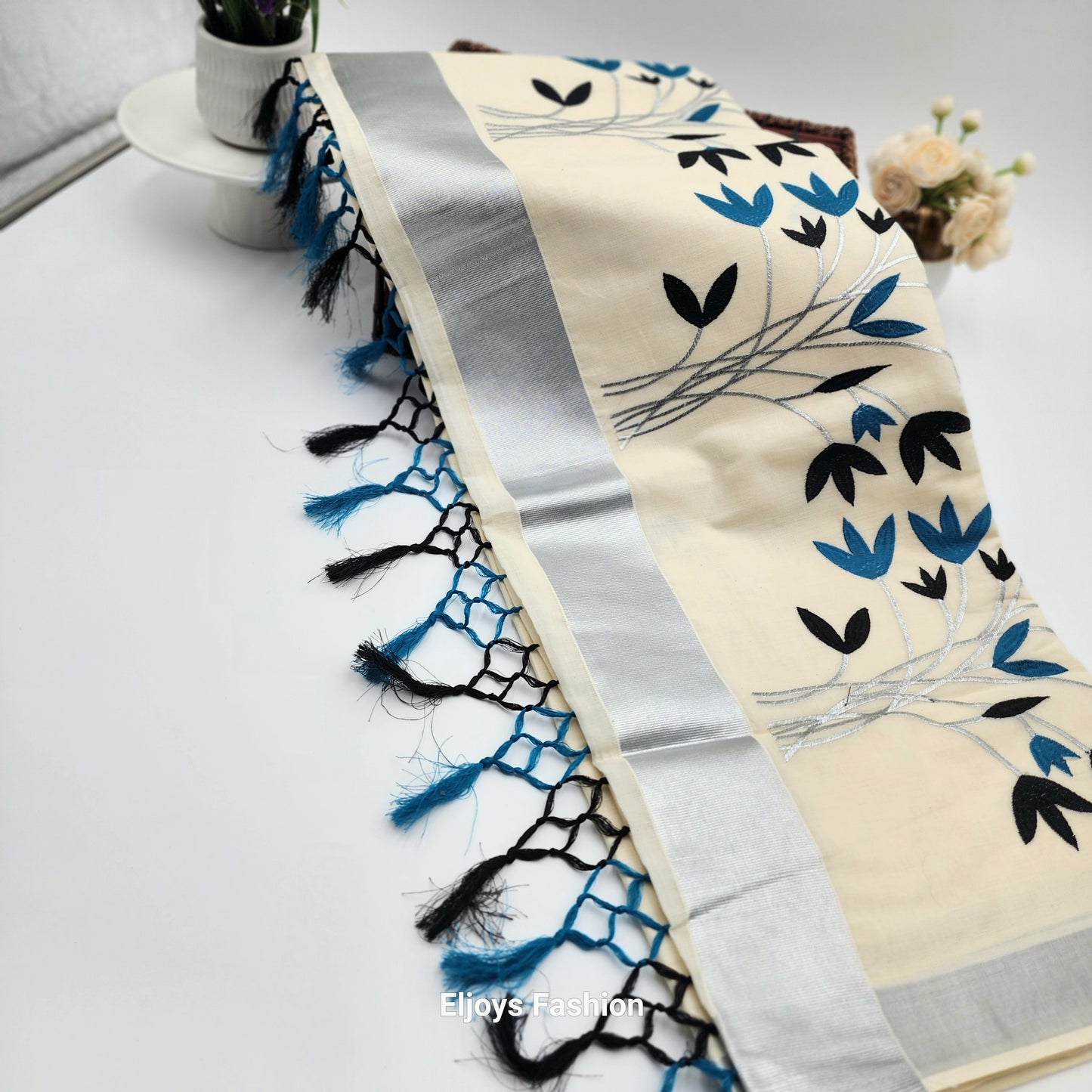 Tissue Silk Saree featuring Silver, Blue and Black floral design with Silver border.