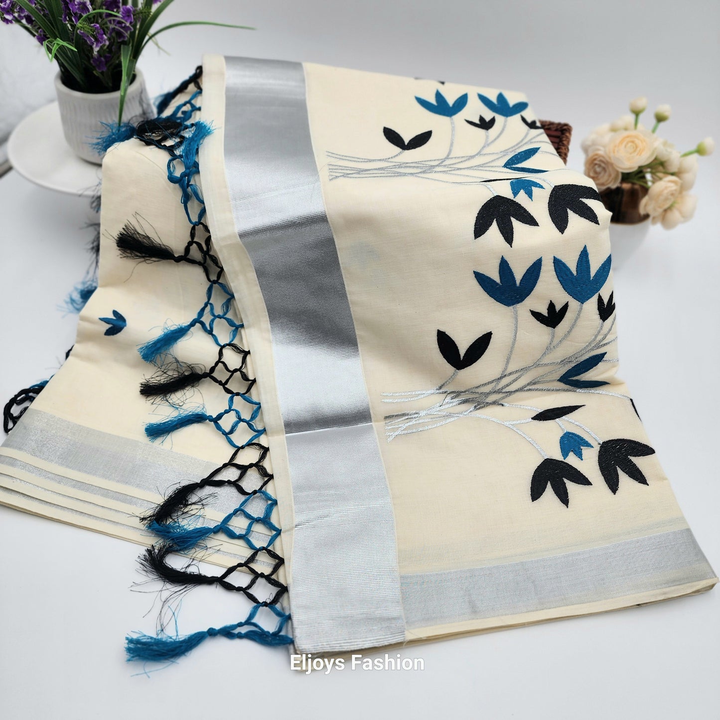 Tissue Silk Saree featuring Silver, Blue and Black floral design with Silver border.