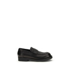 MM6 black calf leather Bos Taurus slip-on loafers showing sleek design and smooth leather finish.
