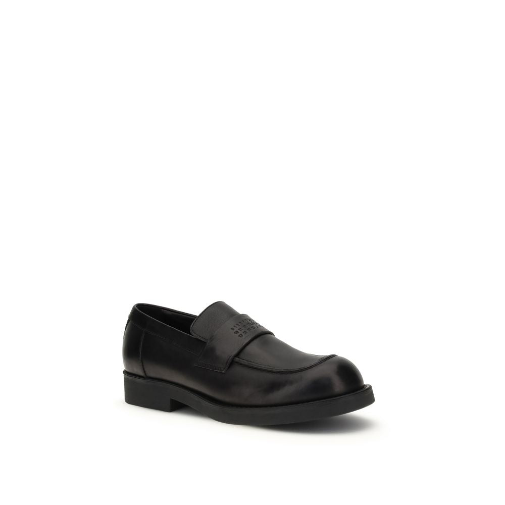 MM6 black calf leather Bos Taurus slip-on loafers with sleek design and rounded toes, perfect for casual or formal wear.
