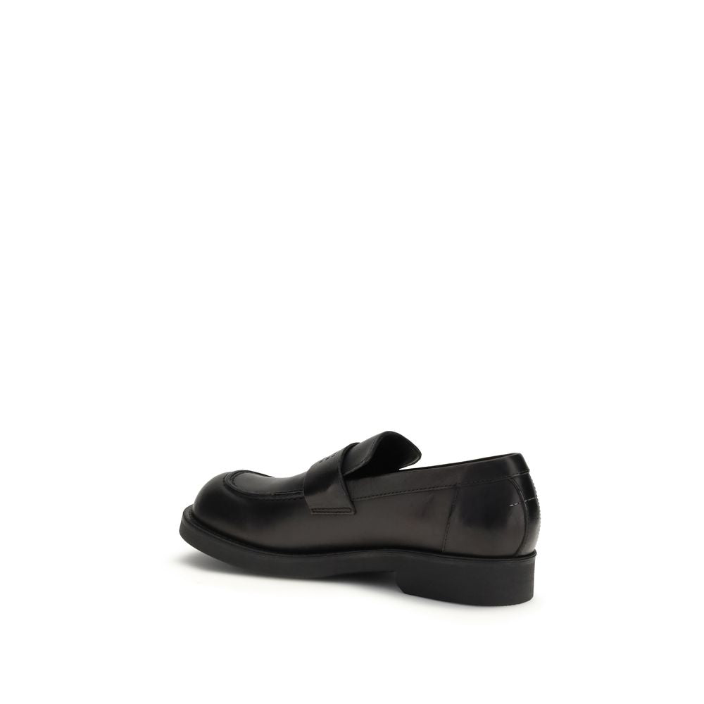 MM6 black calf leather Bos Taurus slip-on loafers with sleek design and rounded toes, stylish footwear for casual or formal wear.