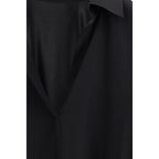 Tom Ford black silk dress shirt with a classic collar and button-front, displayed on a hanger.