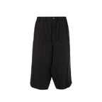 Maison Margiela black linen Bermuda shorts laid flat, showcasing the relaxed fit and minimalist design.