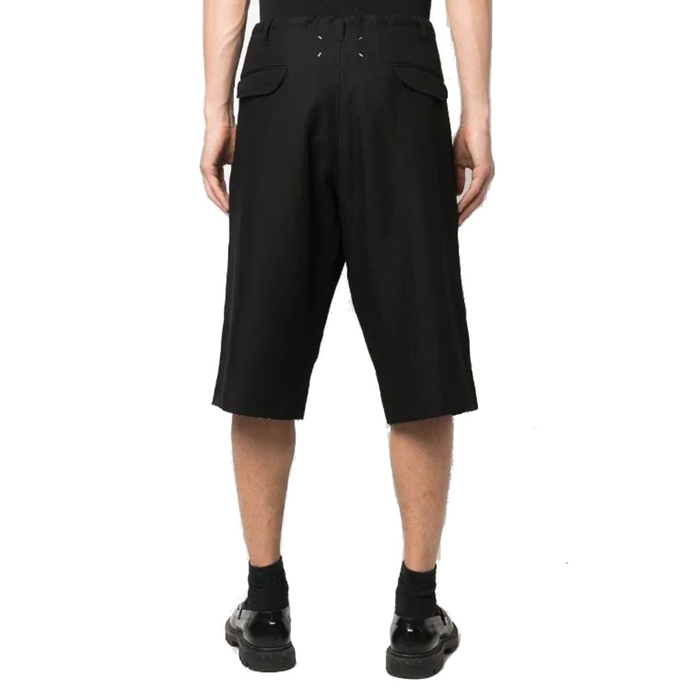 Maison Margiela black linen Bermuda shorts displayed on a hanger, showcasing a relaxed fit and clean design.