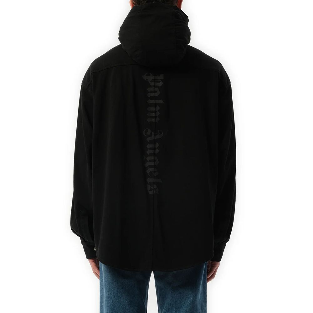 Black denim shirt by Palm Angels with button-up front and classic collar, showcased on a hanger.