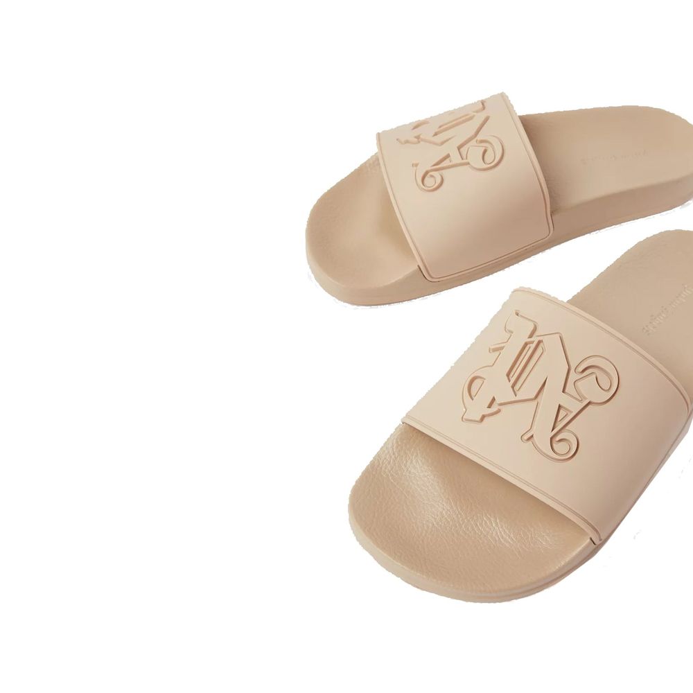 Beige rubber slides by Palm Angels featuring a sleek design and open toe for comfortable casual wear.