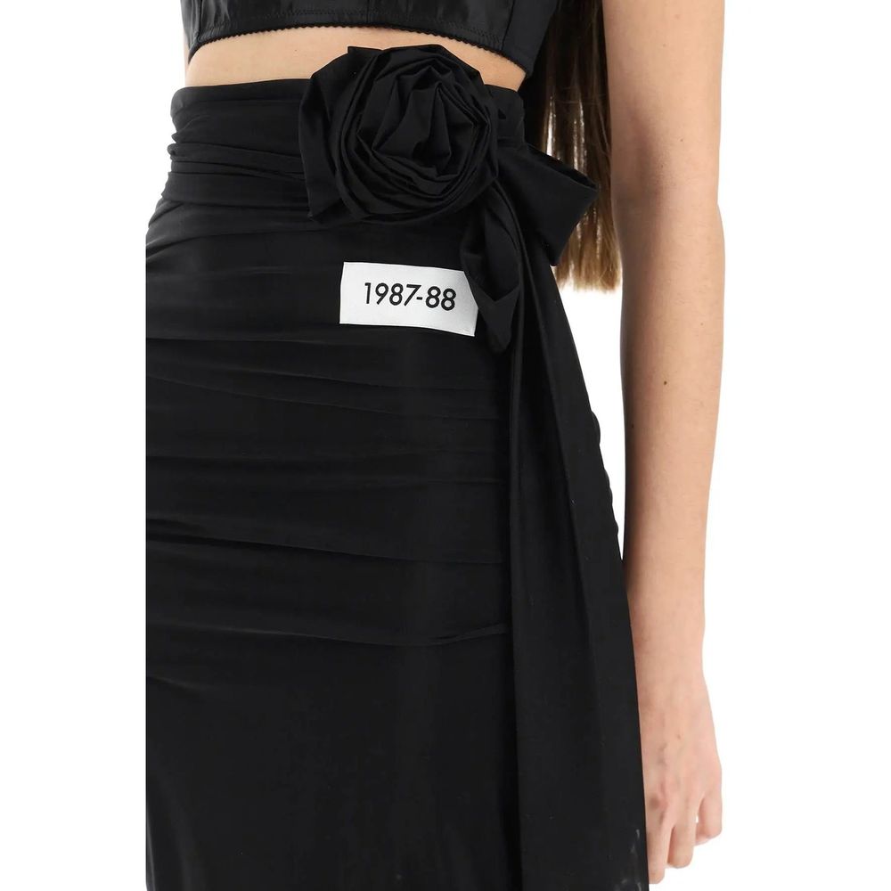 Dolce & Gabbana black elastane long skirt displayed on a model, showcasing a sleek, fitted design with a high waist and flowing silhouette.