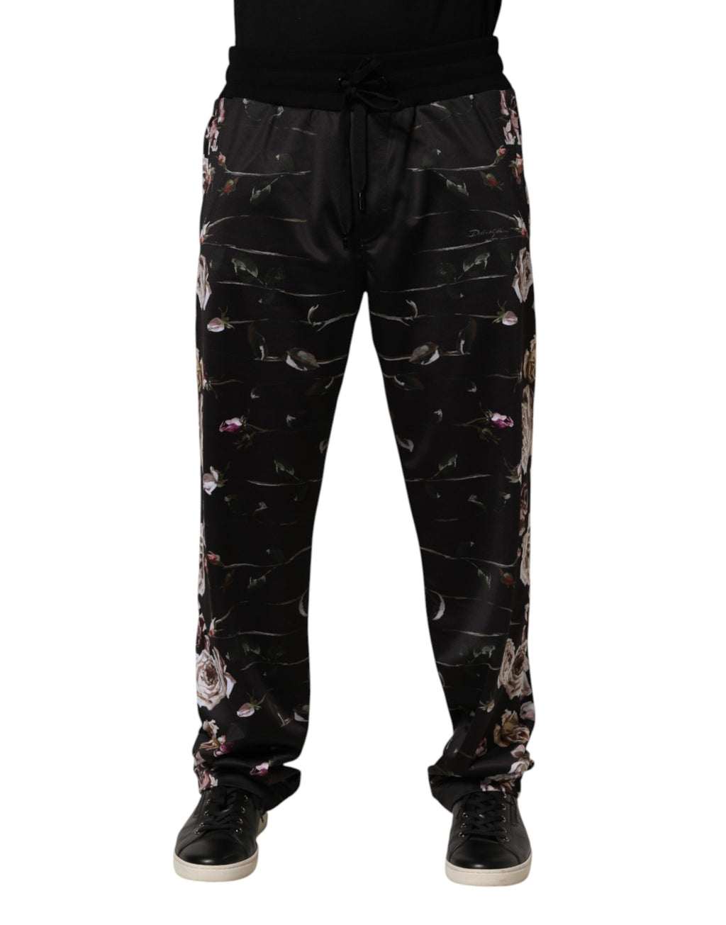 Black floral Dolce & Gabbana straight-leg chino trousers with tailored fit and front pockets, displayed on a hanger.