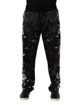 Black floral Dolce & Gabbana straight-leg chino trousers with tailored fit and front pockets, displayed on a hanger.