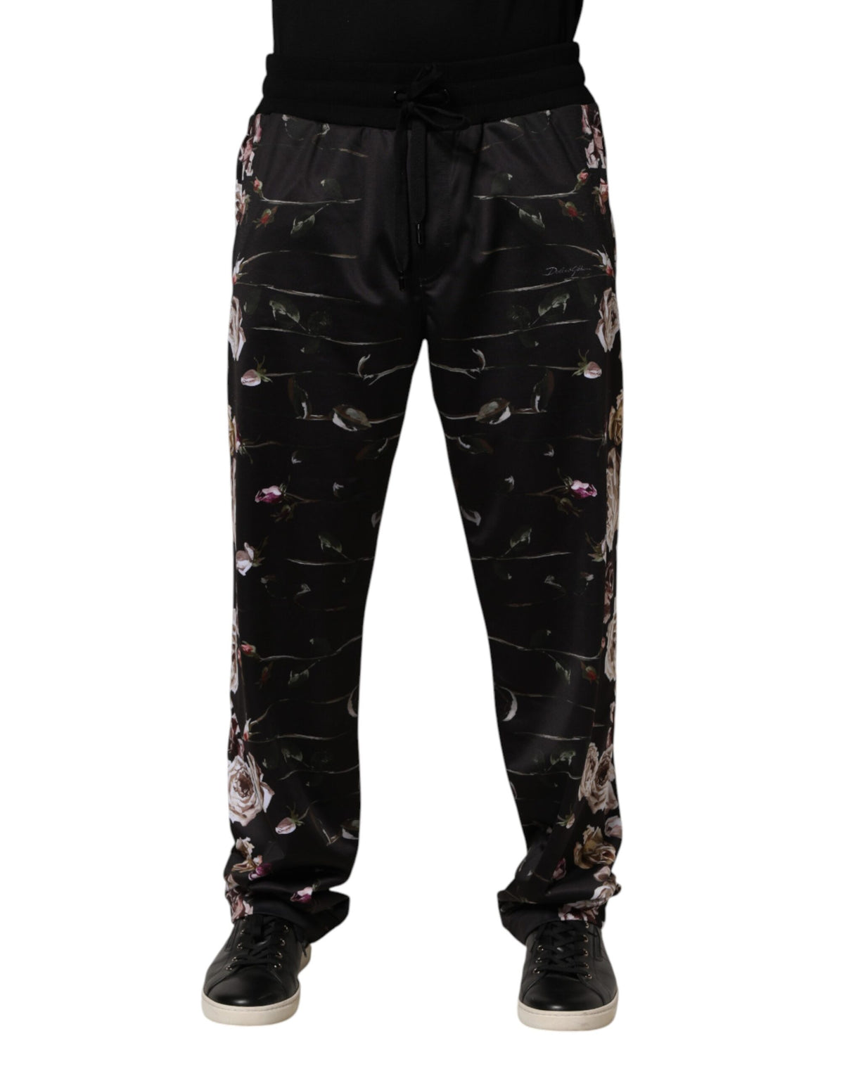 Black floral Dolce & Gabbana straight-leg chino trousers with tailored fit and front pockets, displayed on a hanger.