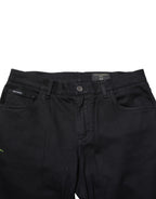 Black floral cotton skinny men's denim jeans by Dolce & Gabbana, showing close-up of floral pattern and fitted style.