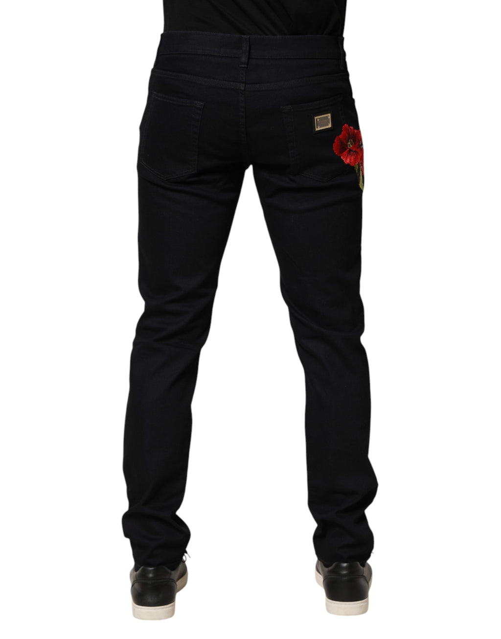 Black floral cotton skinny men's denim jeans by Dolce & Gabbana with detailed floral print and classic five-pocket design.