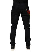 Black floral cotton skinny men's denim jeans by Dolce & Gabbana with detailed floral print and classic five-pocket design.