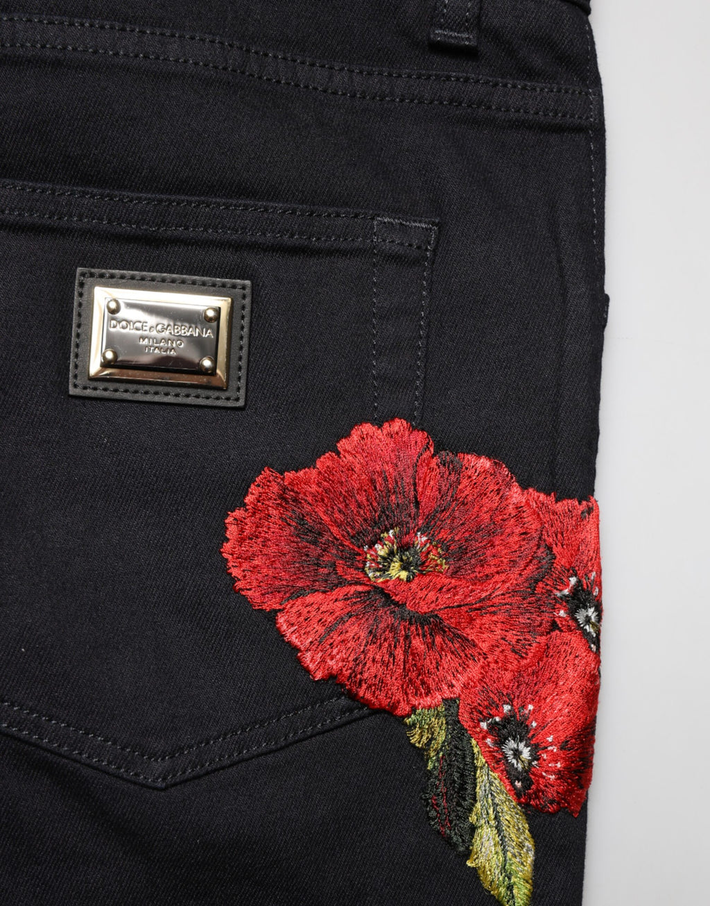 Black floral cotton skinny men's denim jeans by Dolce & Gabbana with a fitted silhouette and floral pattern detail.