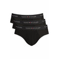 Black cotton men's briefs by Tommy Hilfiger with classic fit and waistband logo, shown laid flat.