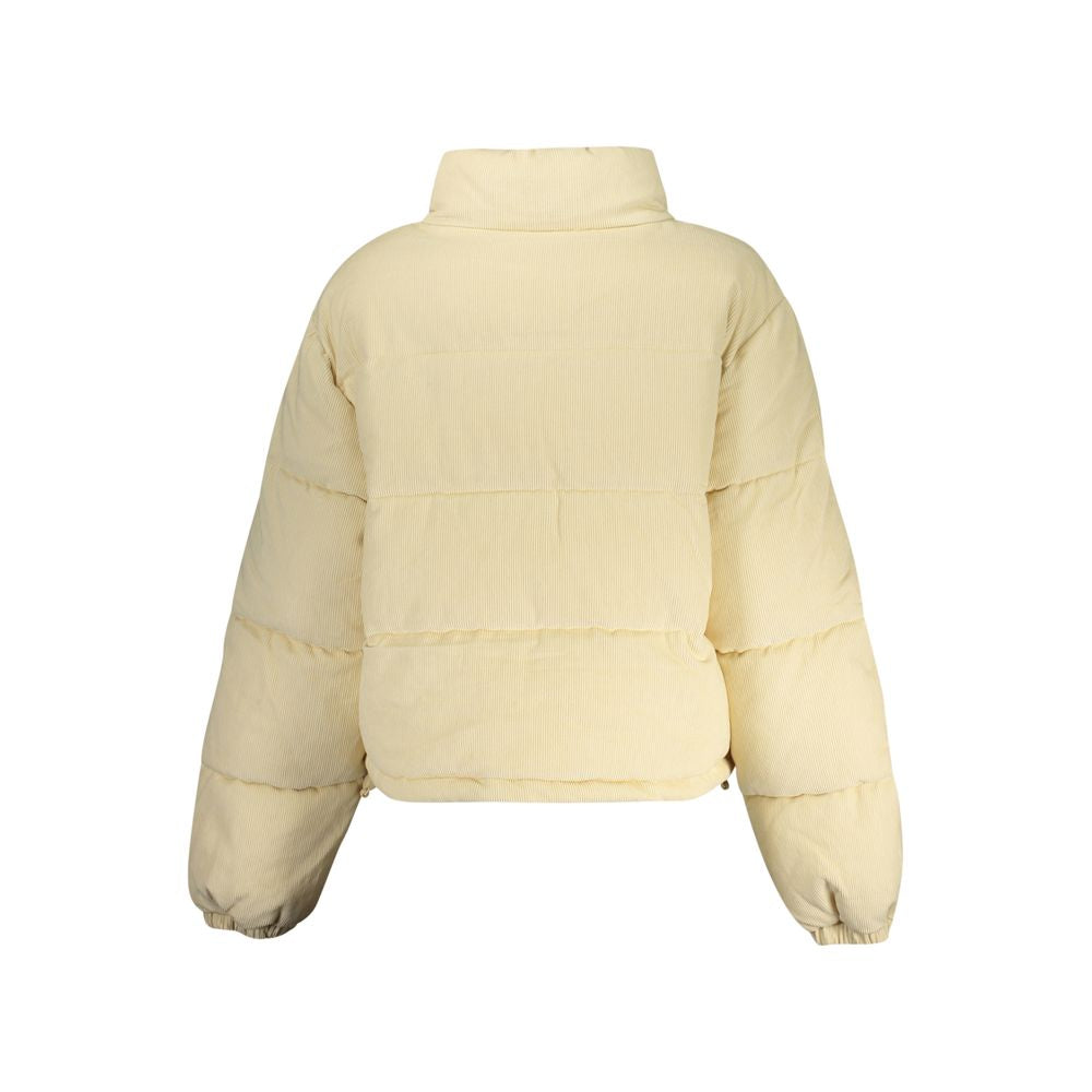 Guess Jeans beige women's polyester jacket with a classic fit, shown hanging on a hanger with a zip front and collar.