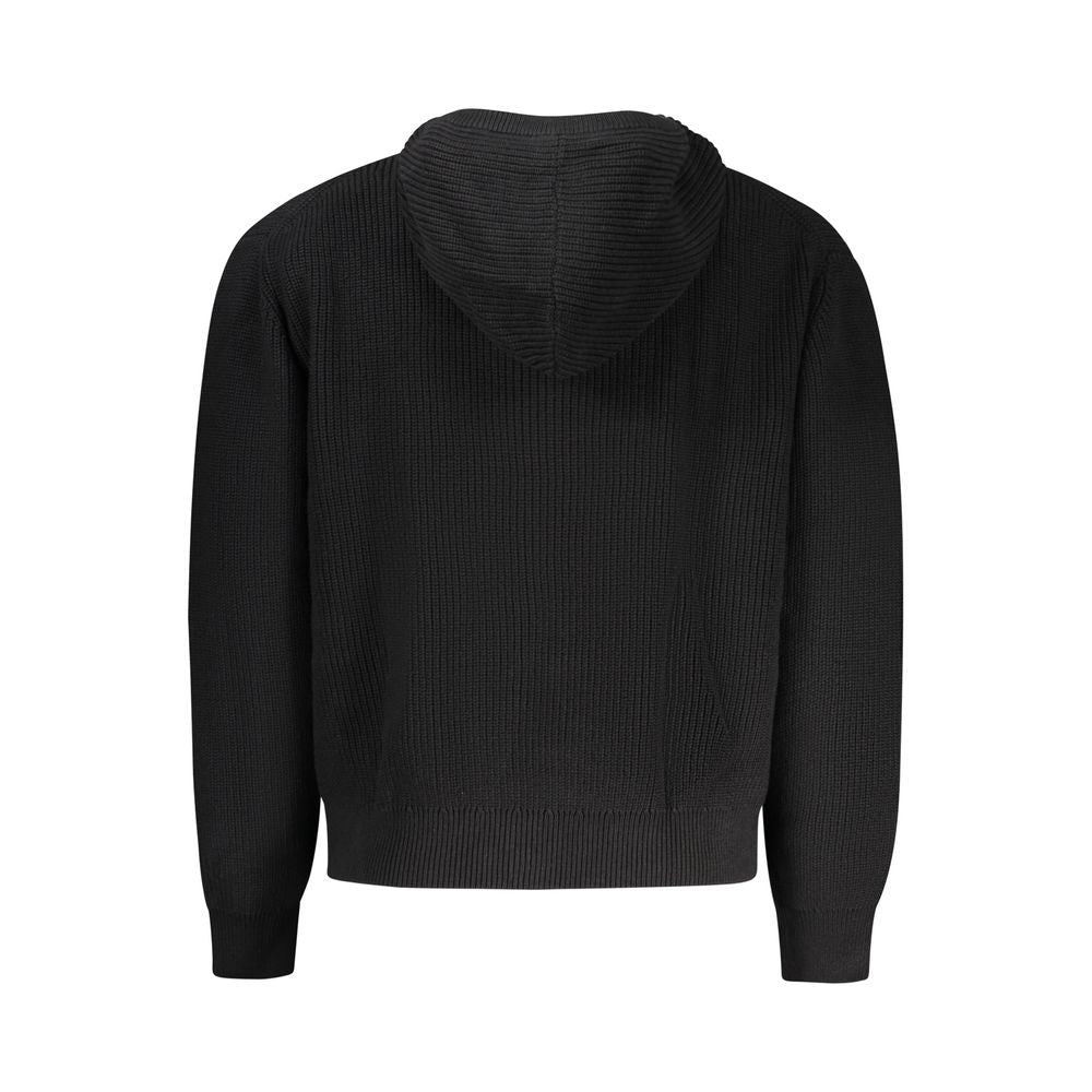 Guess Jeans black organic cotton men's cardigan displayed on a hanger with front buttons and ribbed cuffs.