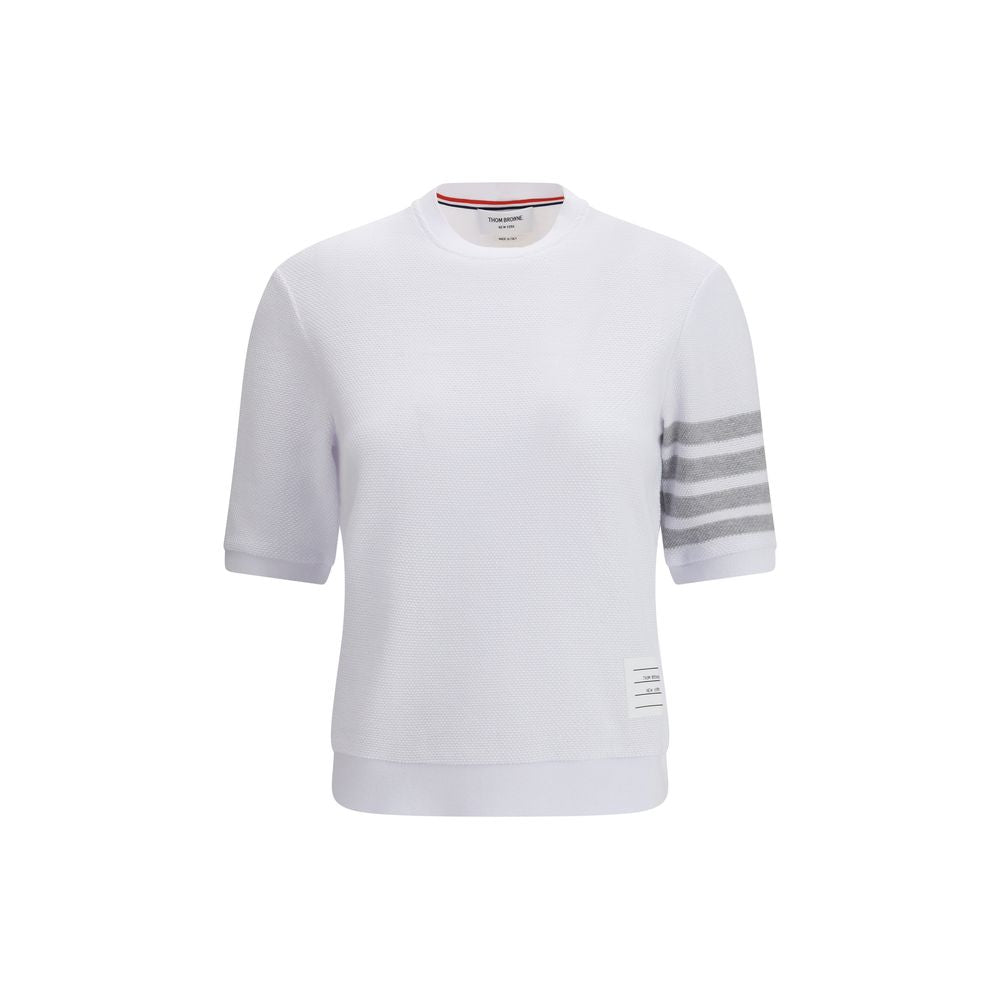 Thom Browne white cotton sportswear with tailored fit and minimalist design, featuring subtle branding and comfortable fabric.