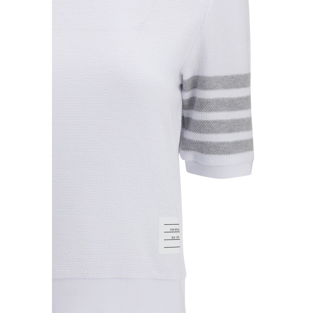 Thom Browne white cotton sportswear, casual athletic clothing with clean design and comfortable fit, displayed on a plain background.