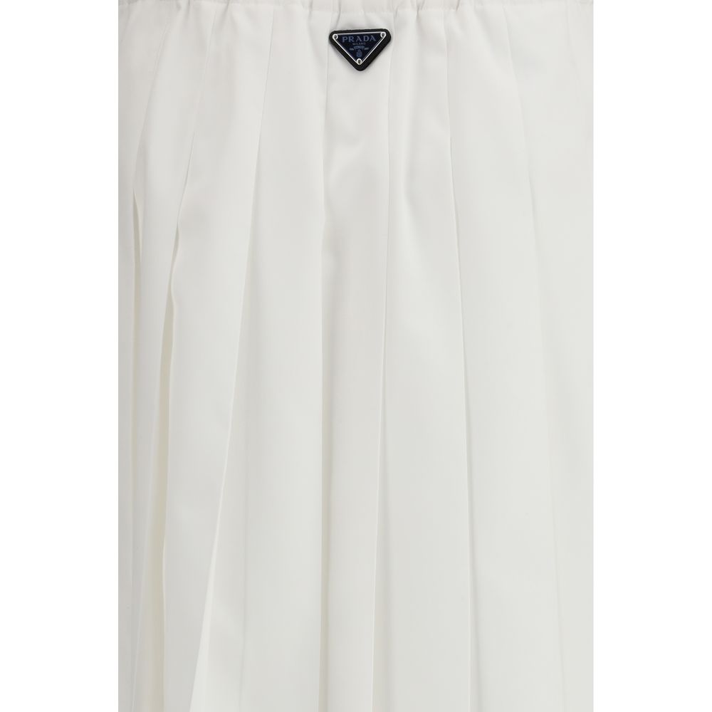 Prada white cotton long skirt with a flowing design, featuring a high waist and elegant style.