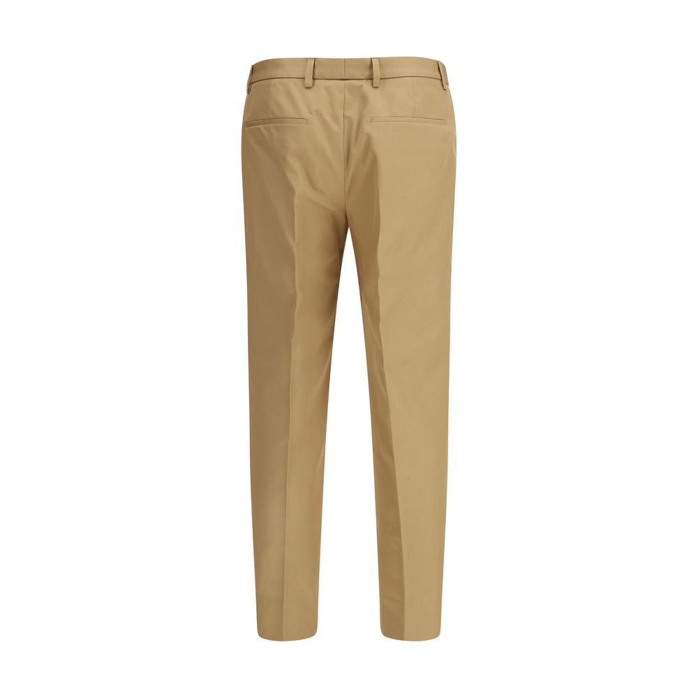 Gucci beige cotton casual pants with a relaxed fit and classic design, displayed on a model.