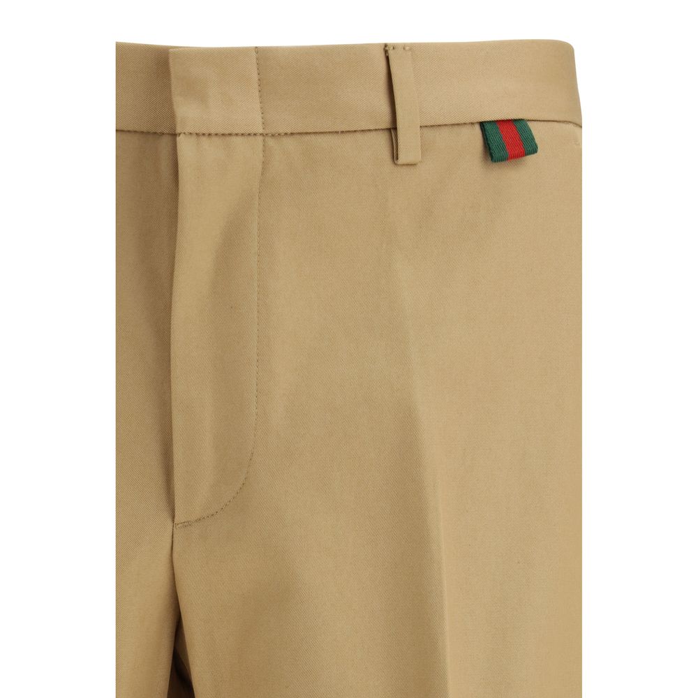 Gucci beige cotton casual pants displayed flat with waistband and pockets, showcasing relaxed, comfortable style.