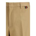 Gucci beige cotton casual pants displayed flat with waistband and pockets, showcasing relaxed, comfortable style.
