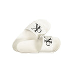 Calvin Klein white polyurethane men's slipper with slip-on design and cushioned sole, ideal for casual indoor wear.