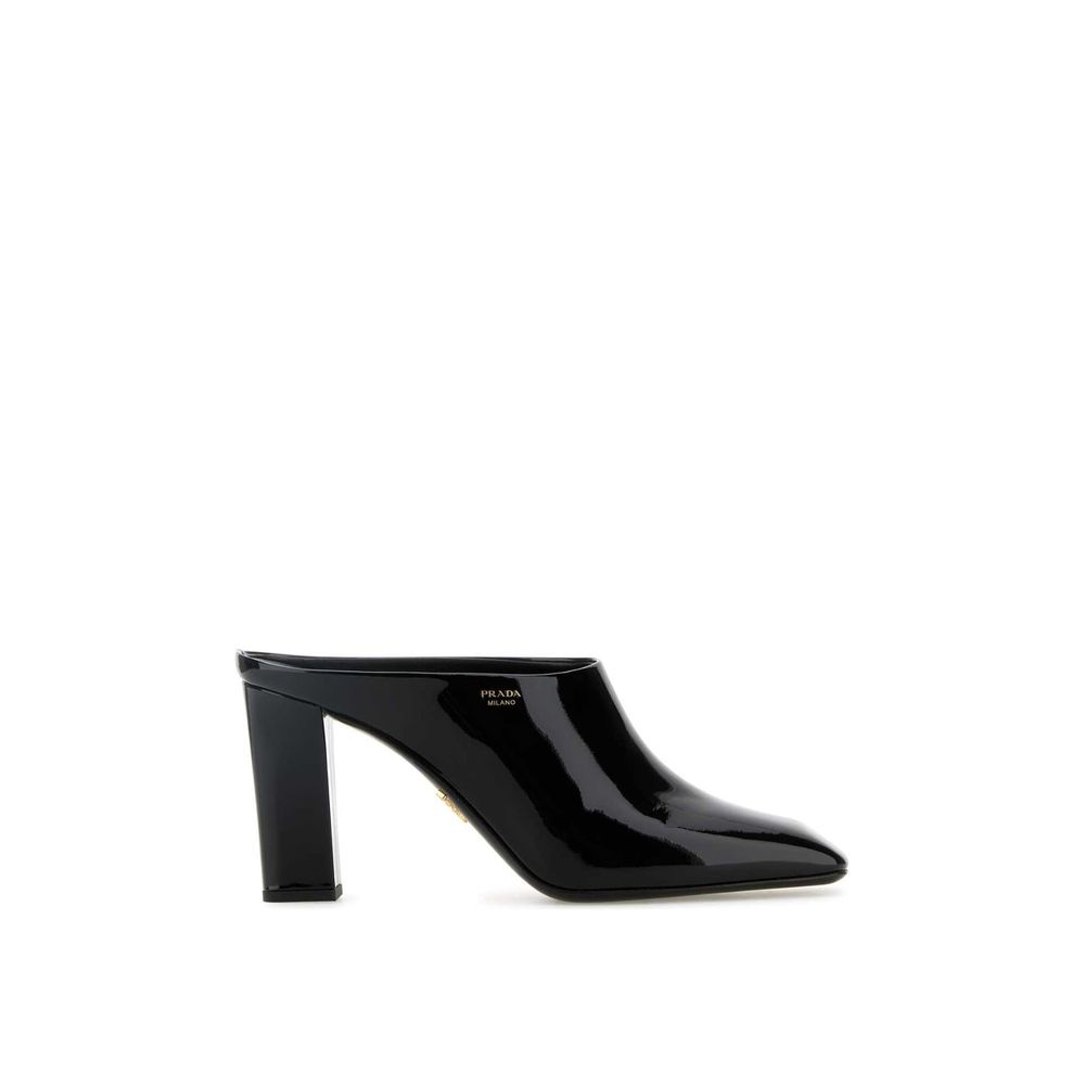 Prada black calfskin mules with pointed toes and low block heels, showcasing sleek and elegant footwear design.