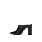 Prada black calfskin mules with pointed toes and slip-on design, showcasing sleek, stylish footwear for women.