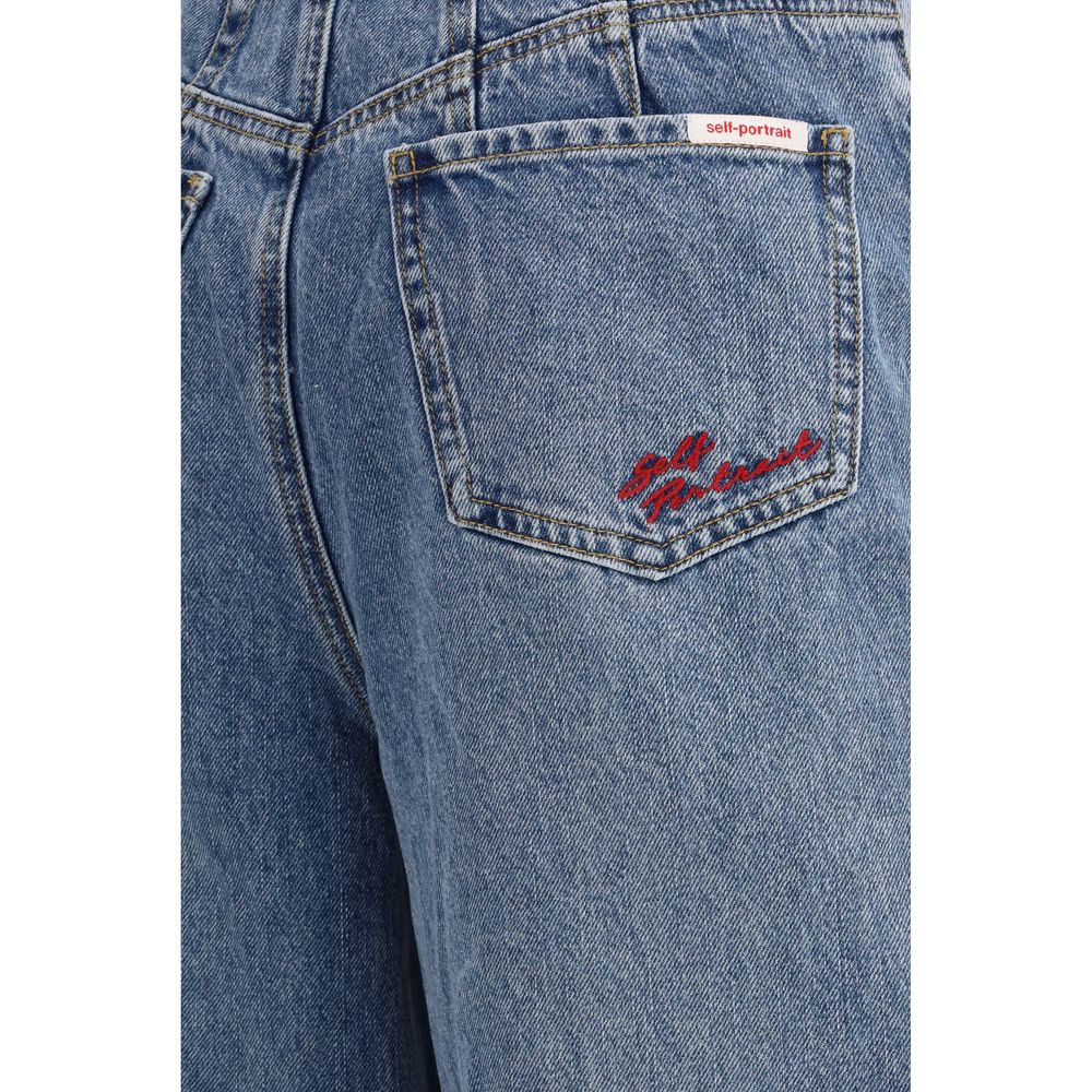 Self-Portrait blue cotton relaxed fit jeans displayed on a hanger, showcasing casual, comfortable denim style.