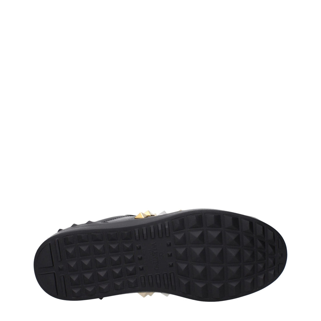 Valentino Garavani black leather sneakers with sleek design and white rubber soles, stylish footwear for casual wear.
