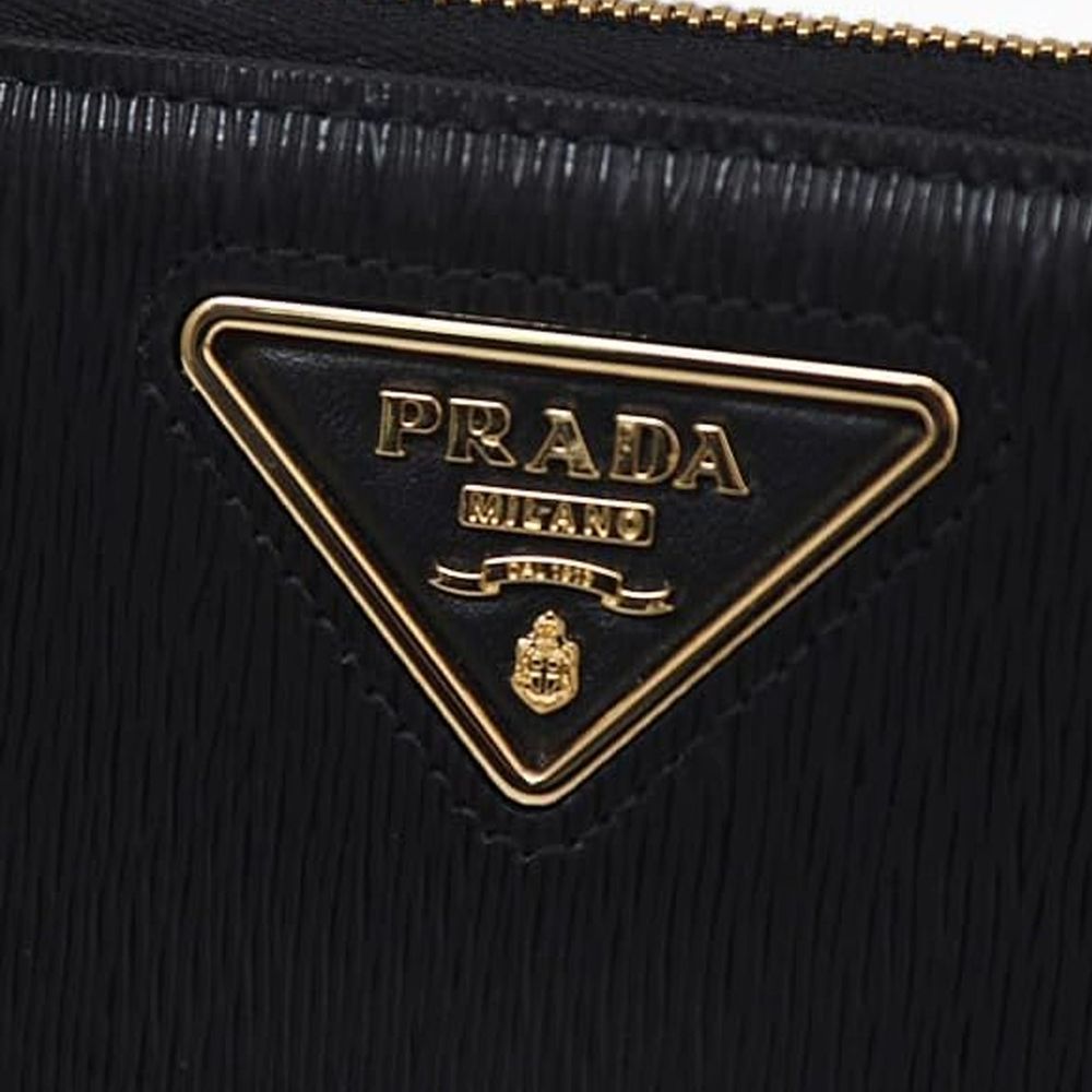 Prada black calfskin wallet with sleek design and subtle branding, featuring multiple card slots and a compact silhouette.