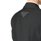 Prada gray wool blazer with tailored fit and classic lapel, displayed on a hanger against a neutral background.