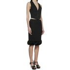 Black silk skirt by Saint Laurent, shown on a model, featuring a sleek, elegant design with a high waist and flowing fabric.