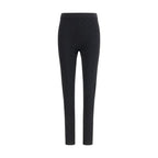 Gucci black viscose leggings displayed on a model, showcasing the sleek fit and smooth fabric.