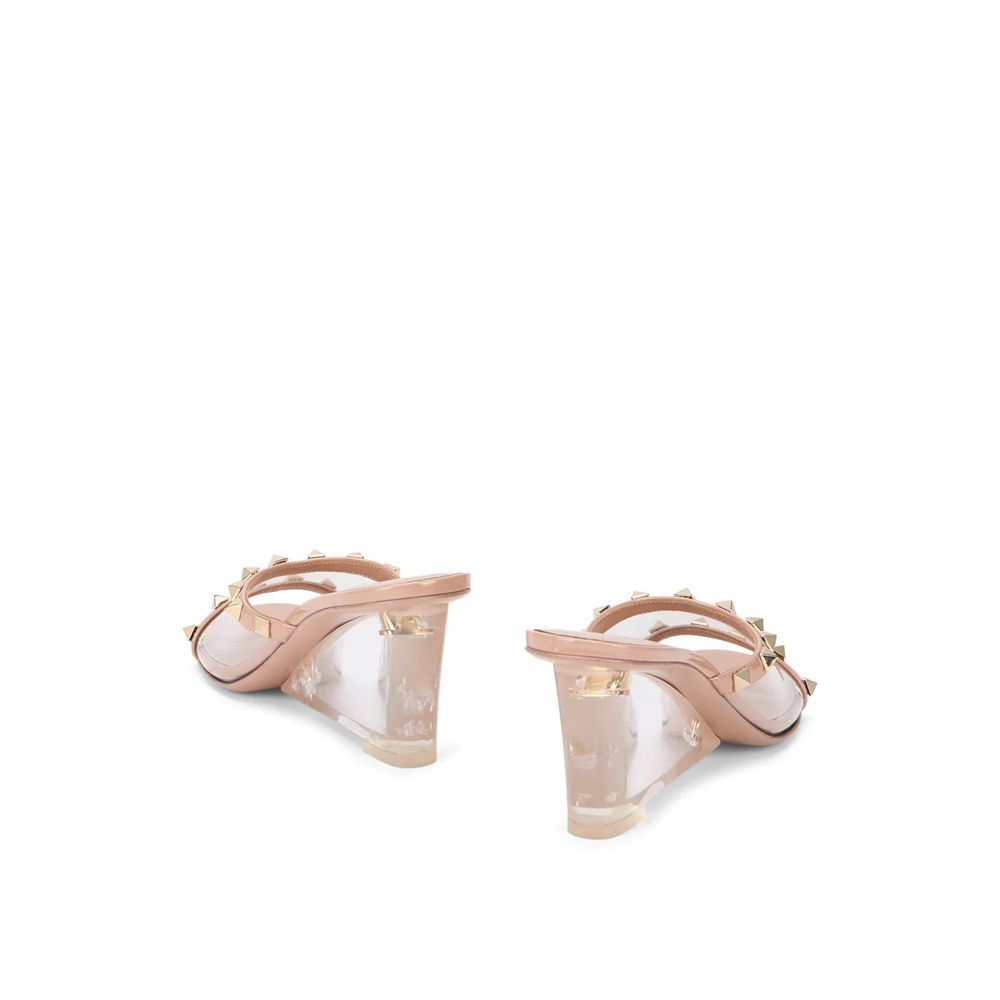 Beige leather Valentino Garavani mules with pointed toes and low block heels, stylish and elegant for women.
