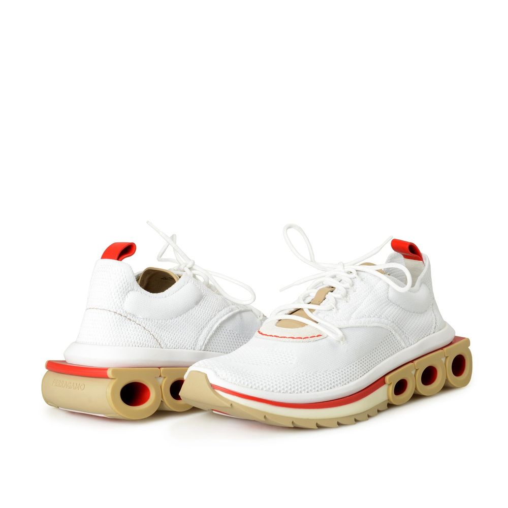 White fabric athletic sneakers by Salvatore Ferragamo with sleek design and lace-up closure.