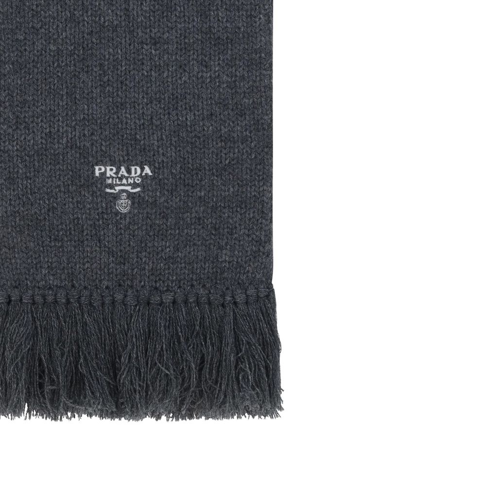 Prada gray cashmere scarf draped over a neutral background, showcasing soft fabric and elegant, luxurious texture.