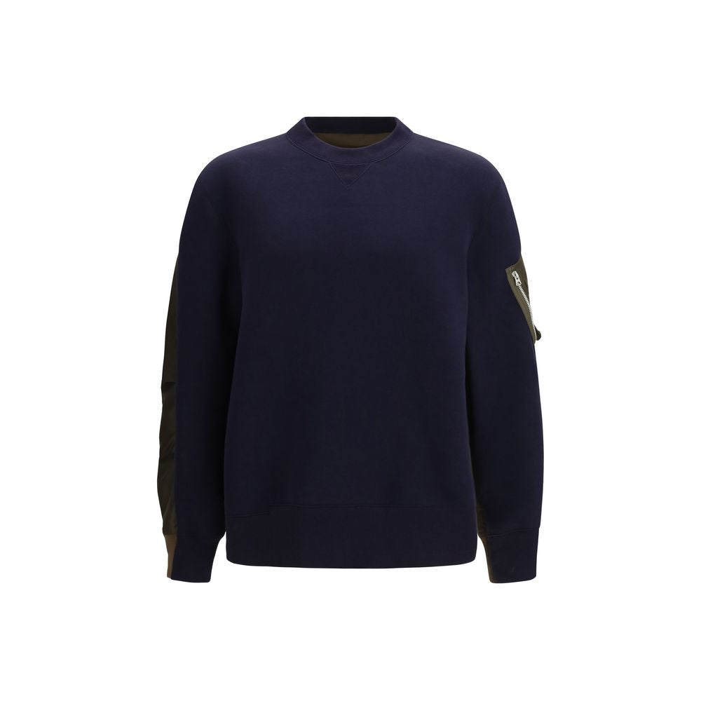 Sacai blue cotton sweatshirt with a relaxed fit, featuring a crew neckline and ribbed cuffs, styled casually on a model.