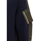 Sacai blue cotton sweatshirt with relaxed fit and ribbed cuffs, displayed on a plain white background.