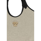 Versace beige cotton shoulder bag with logo detail and adjustable strap, stylish accessory for casual or elegant outfits.