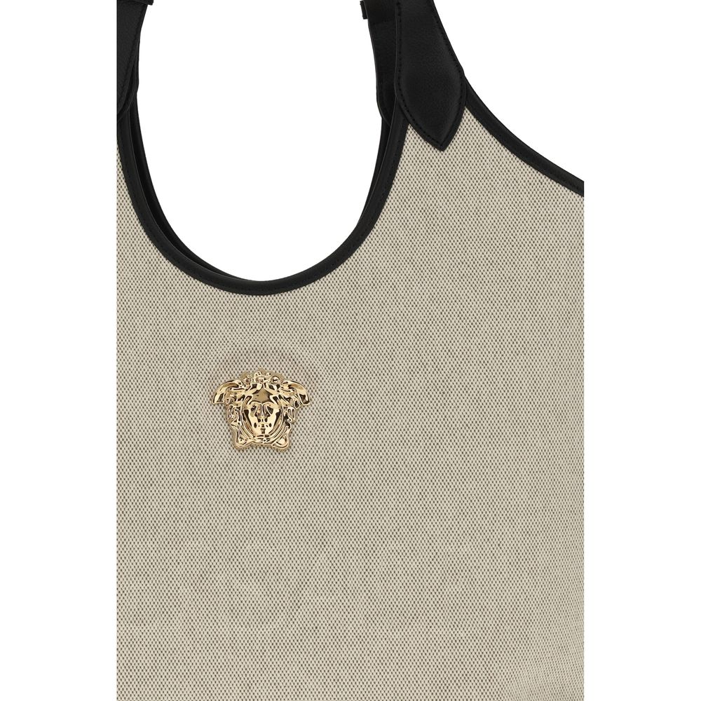 Versace beige cotton shoulder bag with logo detail and adjustable strap, stylish accessory for casual or elegant outfits.