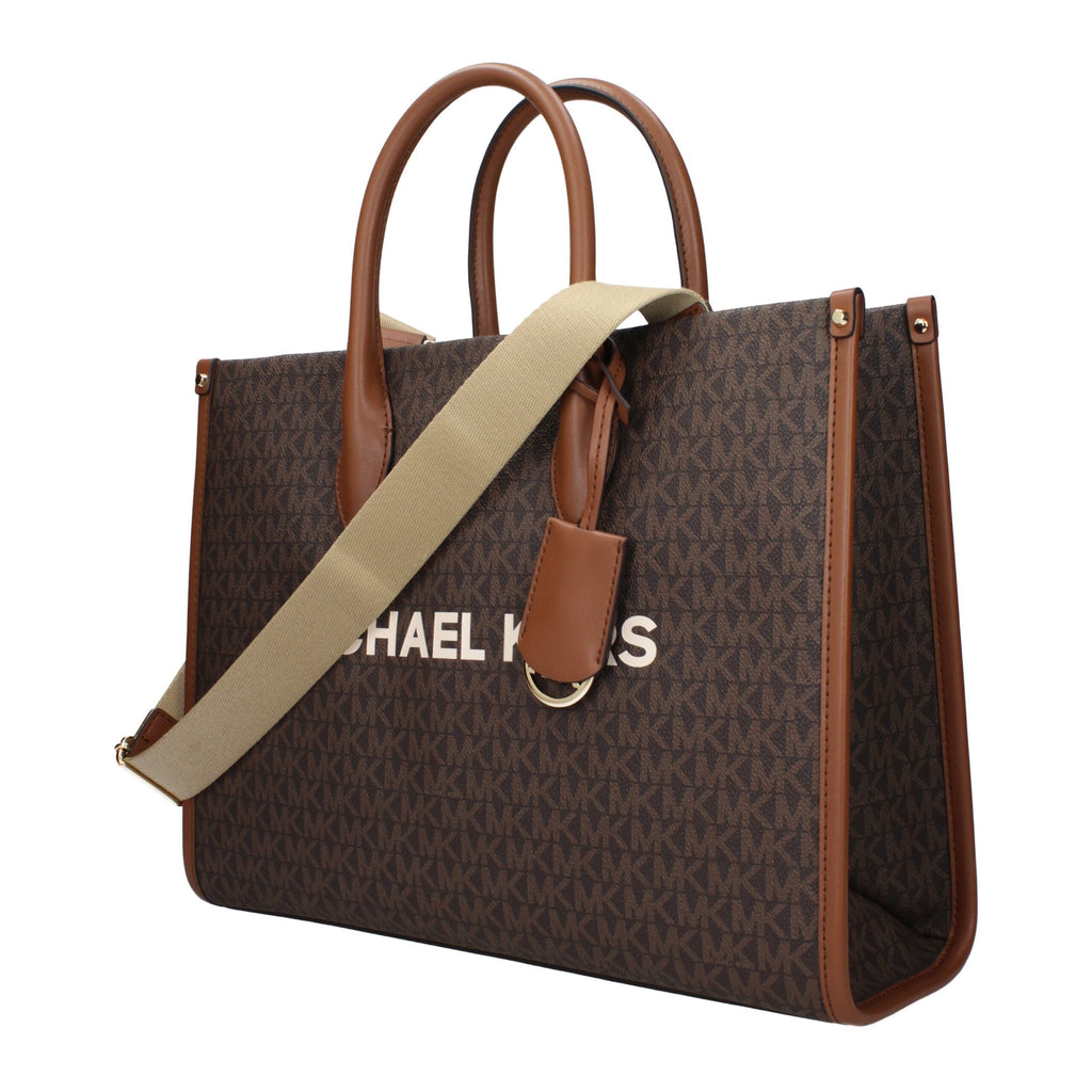 Michael Kors brown fabric handbag with top handles and gold-tone hardware, showcasing a stylish and spacious design.