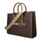 Michael Kors brown fabric handbag with top handles and gold-tone hardware, showcasing a stylish and spacious design.