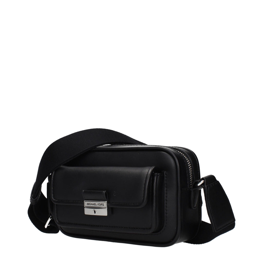 Black leather Michael Kors crossbody bag with gold-tone hardware and adjustable strap, stylish and compact for everyday use.