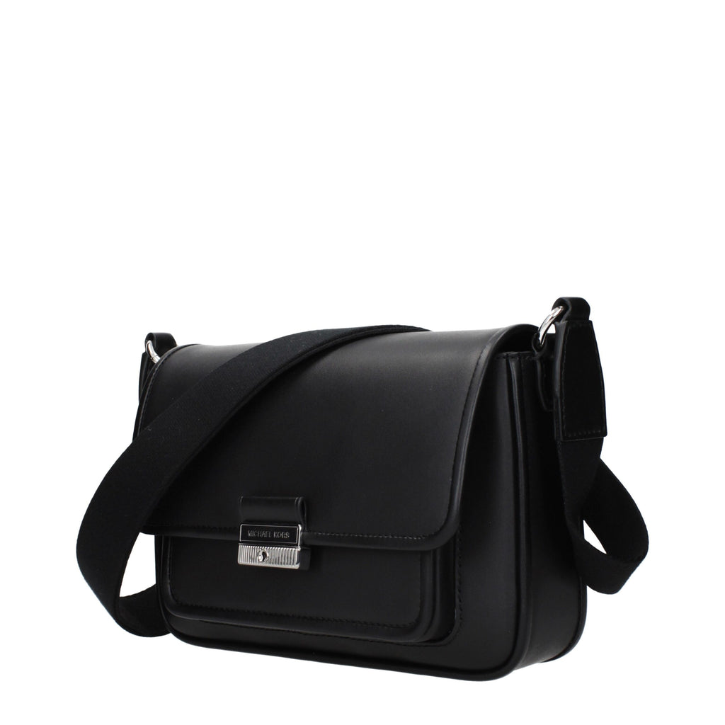 Black leather crossbody bag by Michael Kors with gold-tone hardware and adjustable strap, featuring a sleek, structured design.